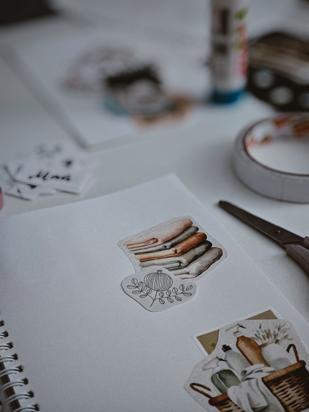 Decorated notebook with stickers resting on a craft desk.